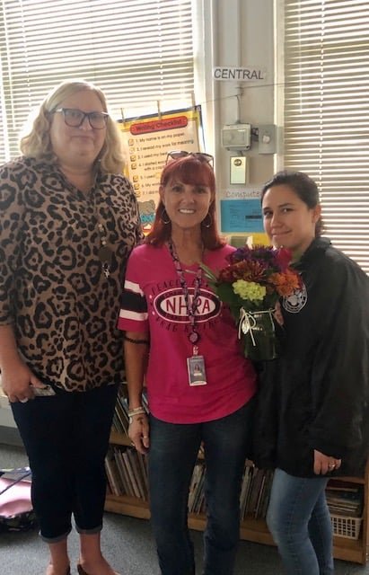 Principal Cynthia Kubit (left) and assistant principal Christie Suarez (right) congratulate school related employee of the year Wendy Lou Fipps.
